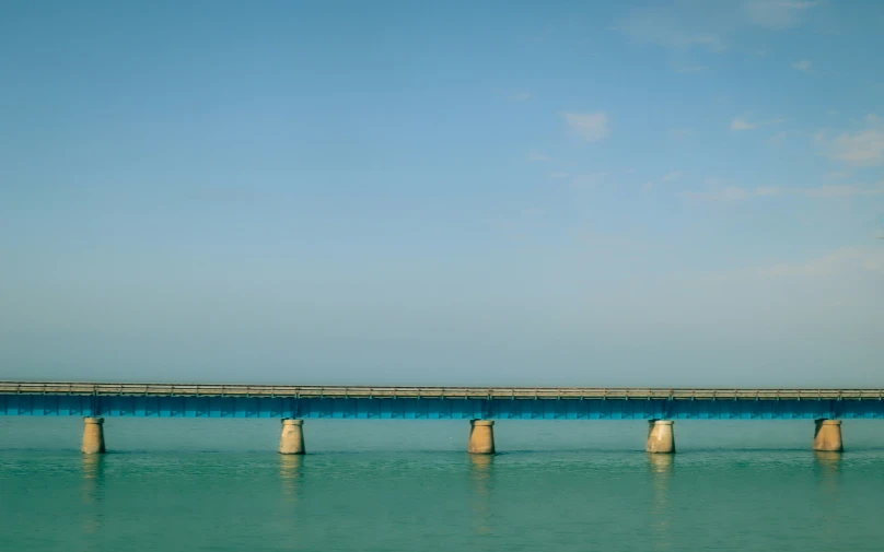 a large bridge spanning over water with a bridge below it