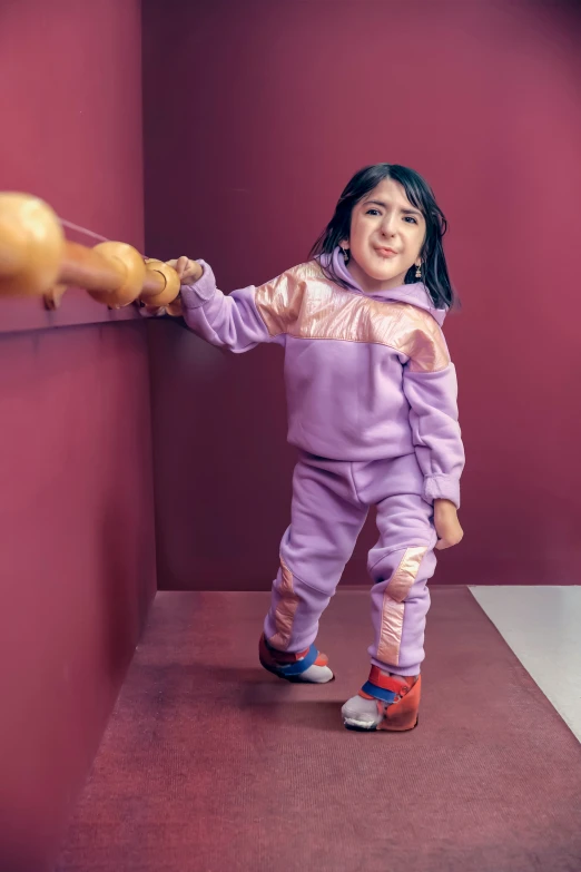 a plastic doll standing next to a wall