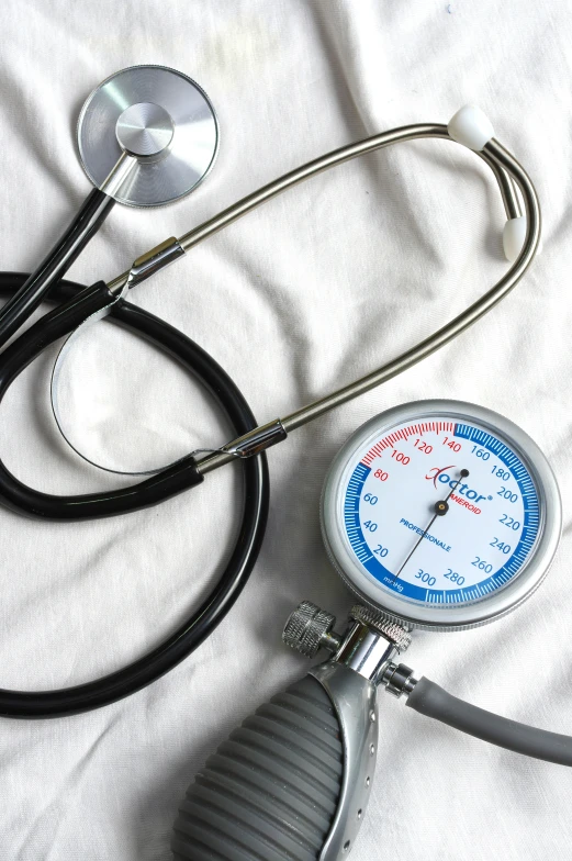 a medical clock sitting on top of a table next to a stethoscope