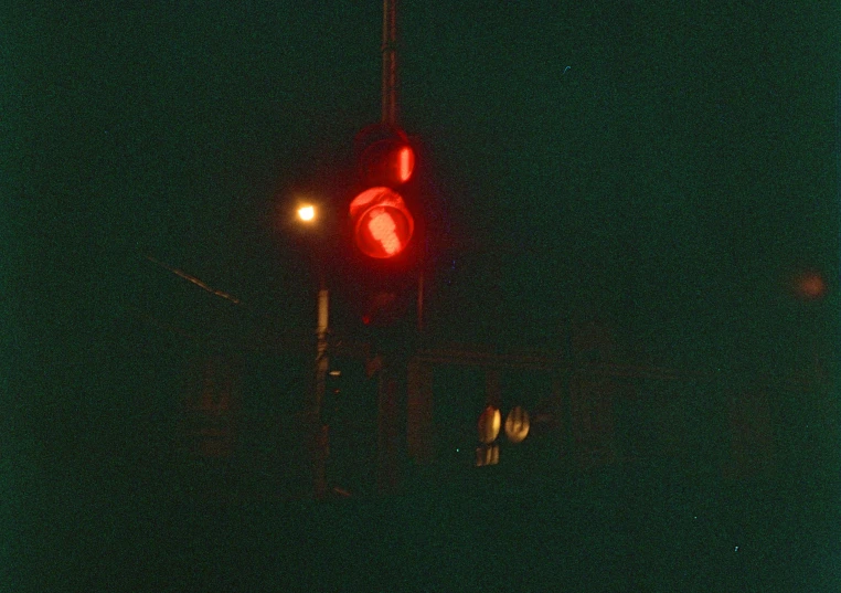 an image of traffic signal with red light at night