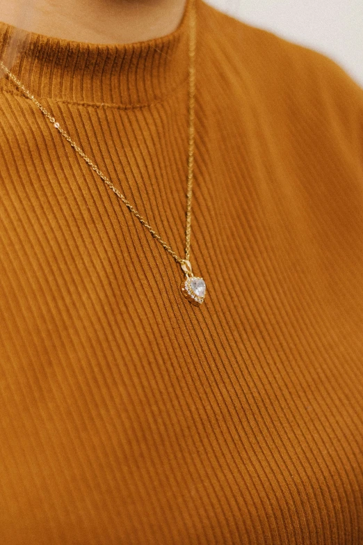 the golden turtle necklace has an intricate white shell and is hanging from a gold chain