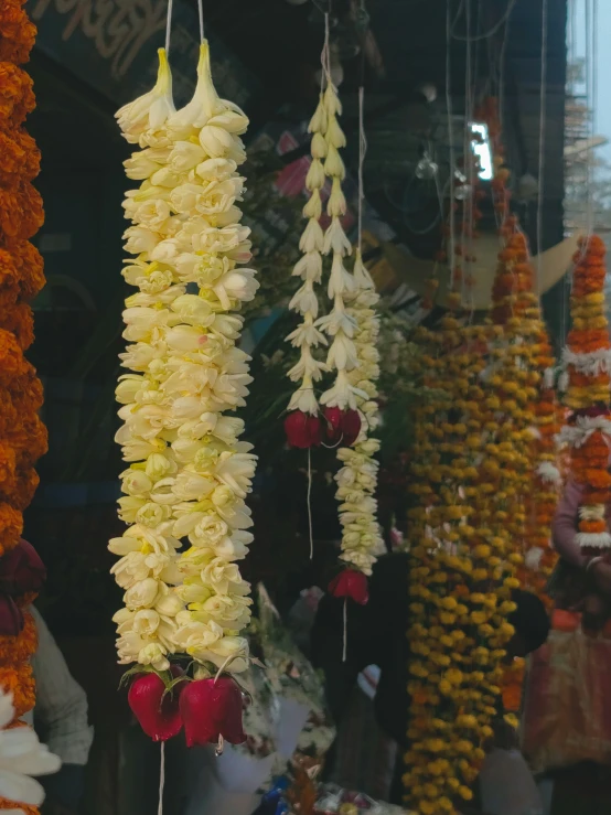 white and yellow flowers hanging from strings outside