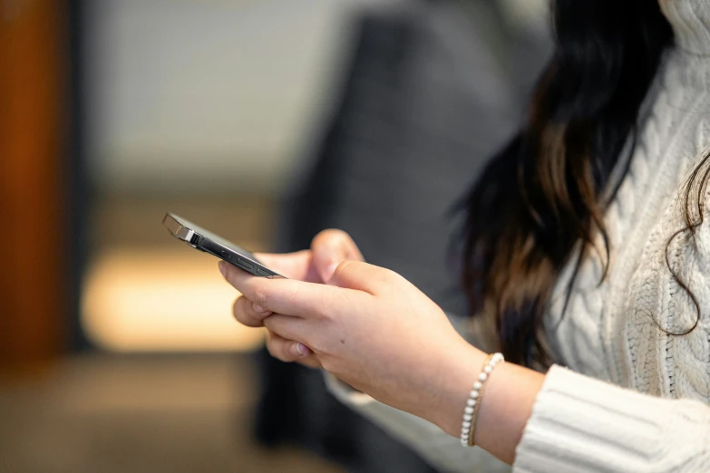 a close up of a person holding a phone