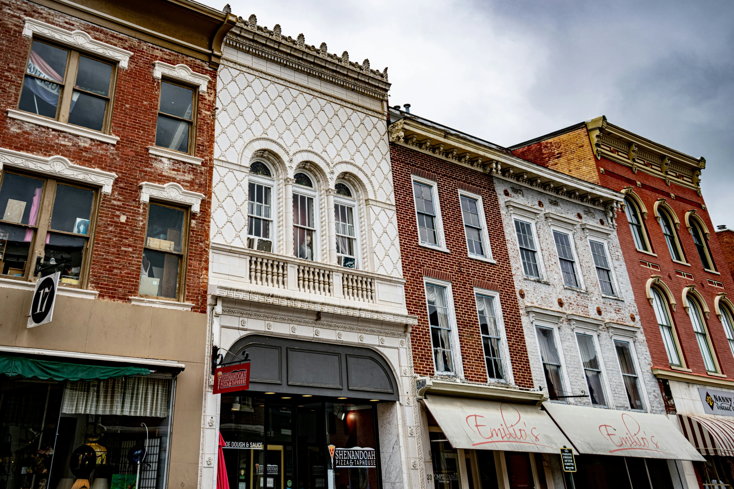 several stores with windows are lined up on a city street