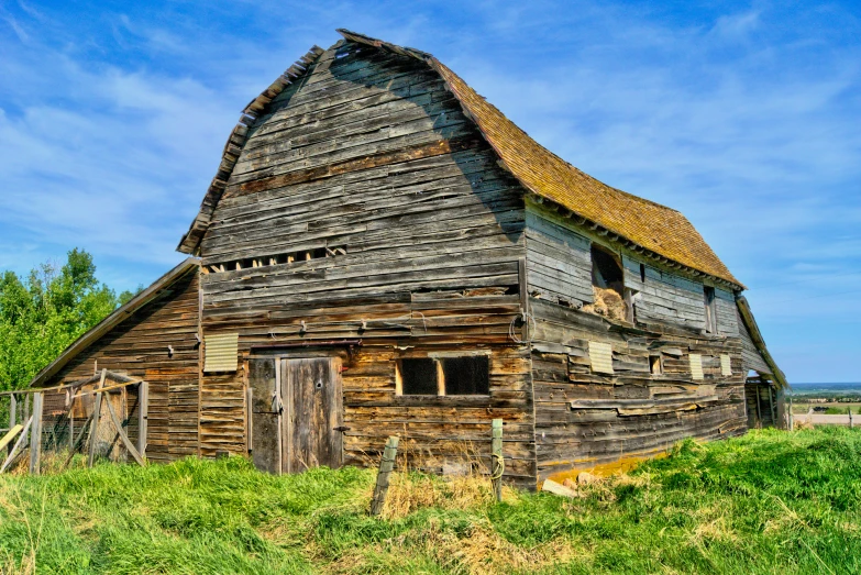 an old house that is in the grass