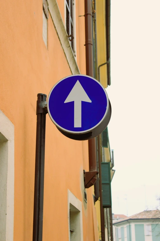 a close up of a blue street sign on a building