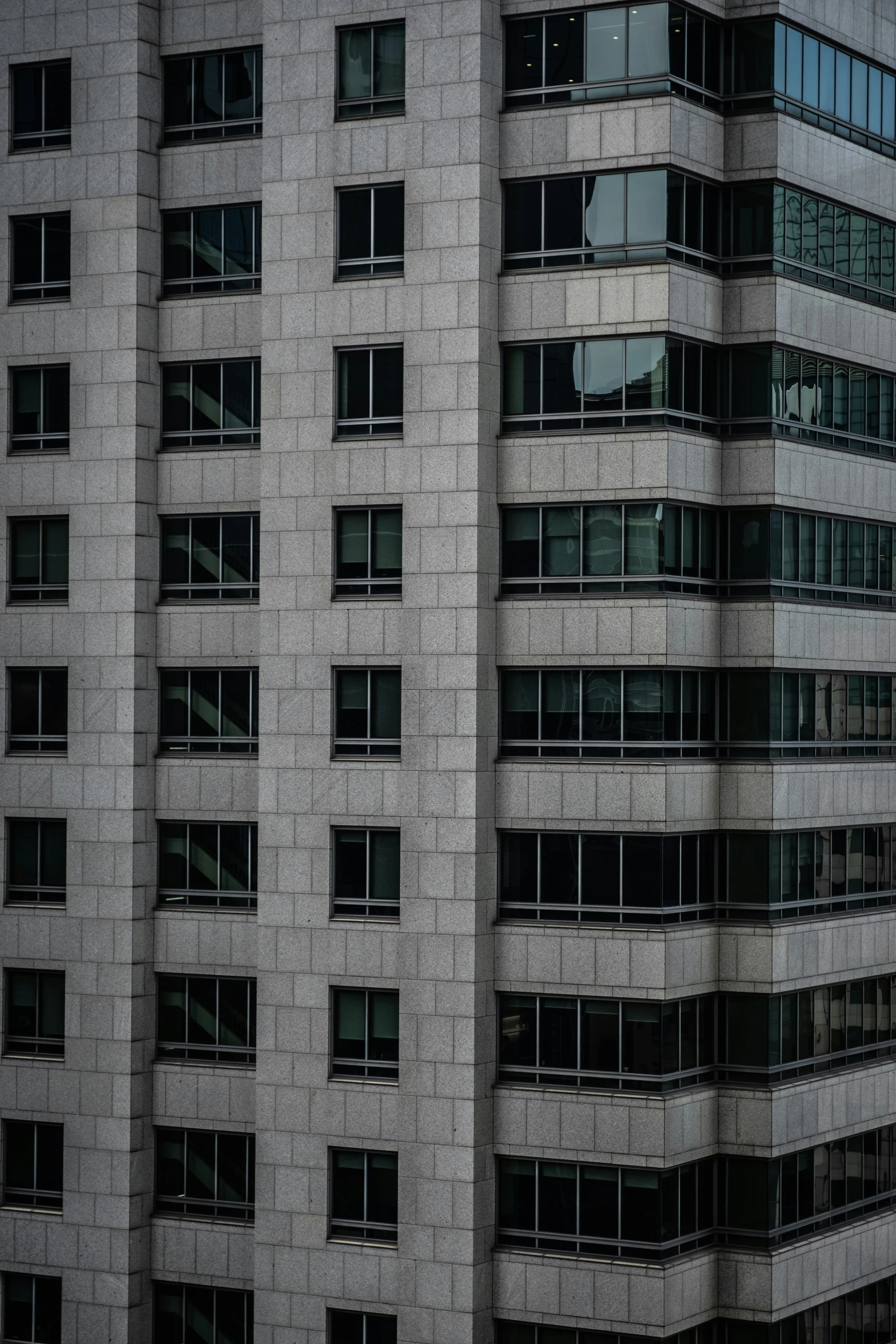 the exterior of an office building with black windows