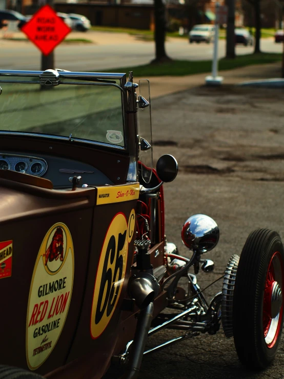 a brown car with an engine and chrome wheels