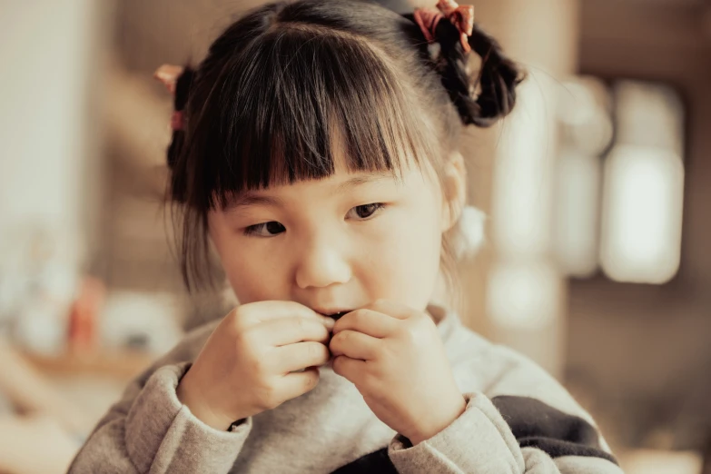 a child in the po holding her hand up to her face