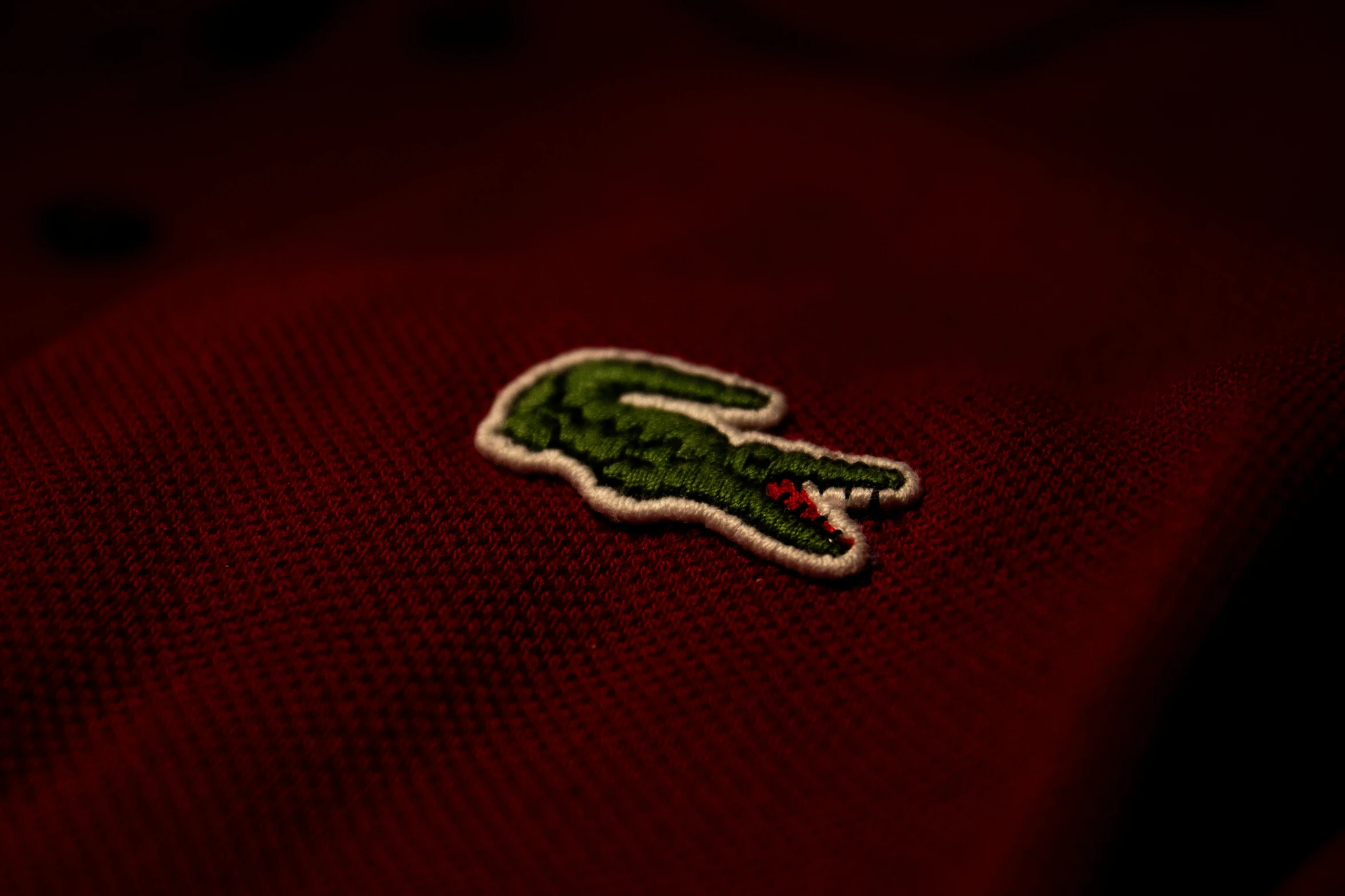 closeup of a small laccoline alligator on the front of a polo shirt