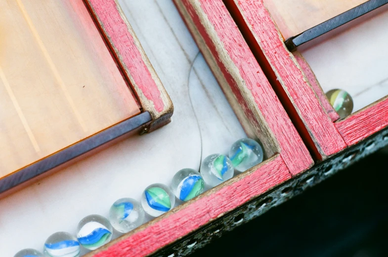 two mirrors and a shelf with different colored glass s