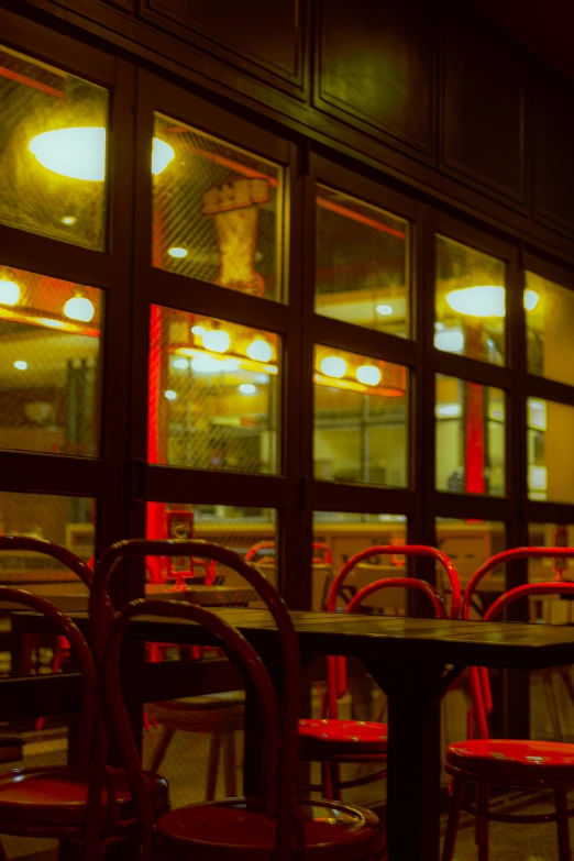 several tables and chairs at an empty restaurant in the evening