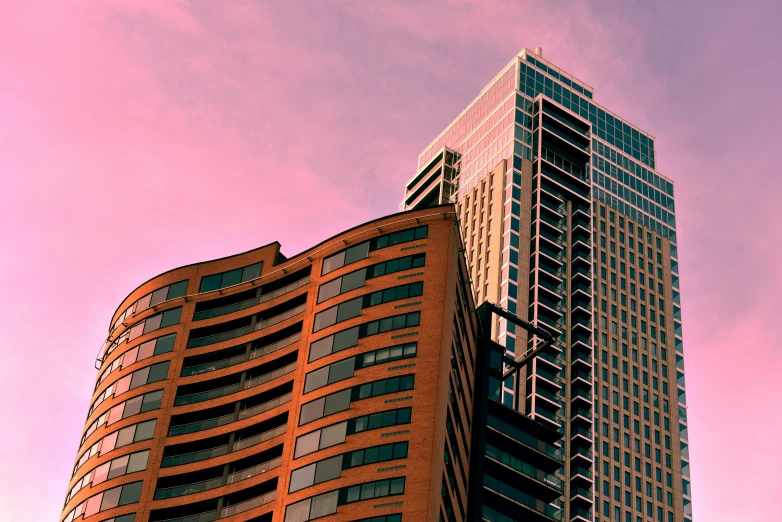 two building are looking up at the sky