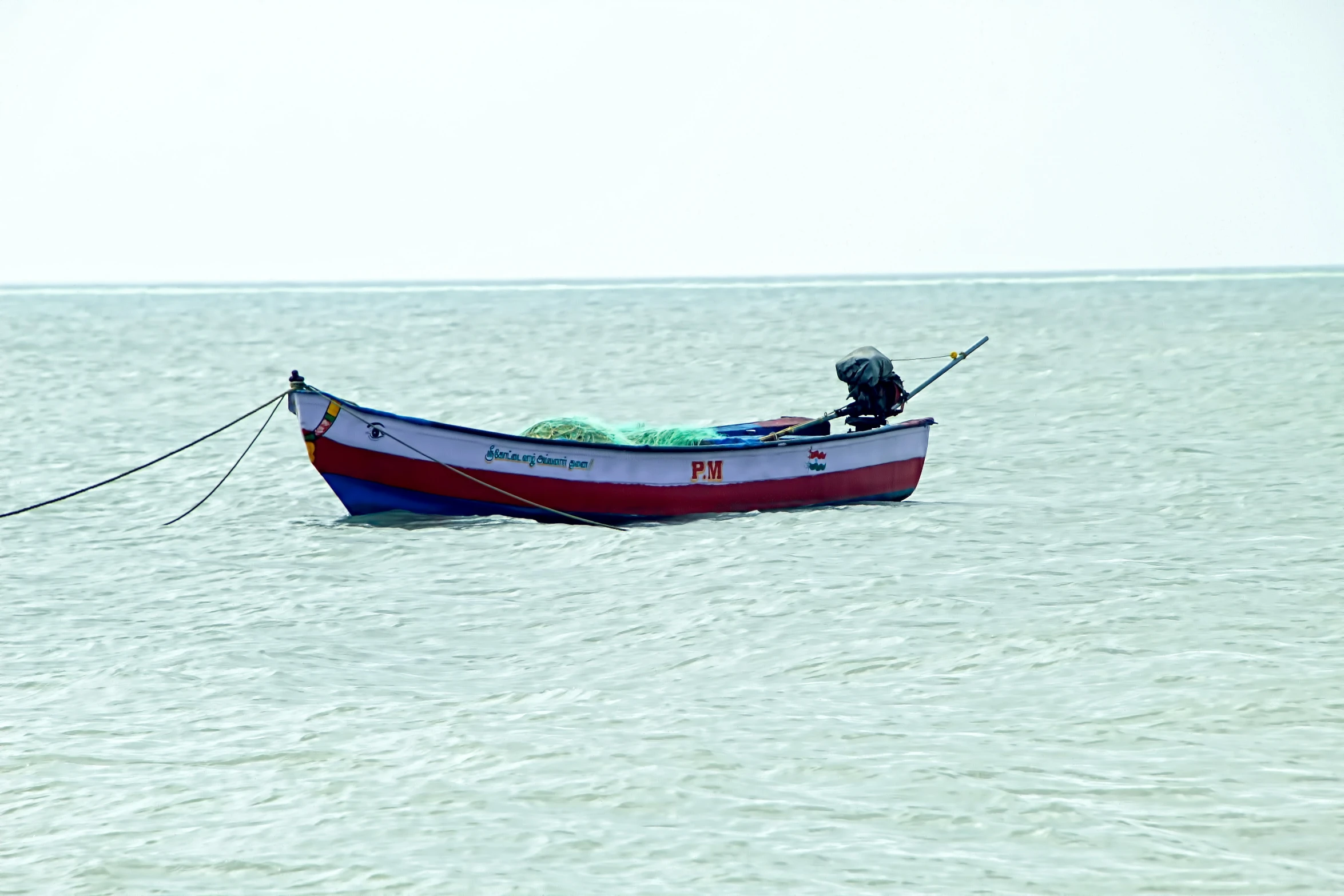 a man in a red and blue boat is in the water