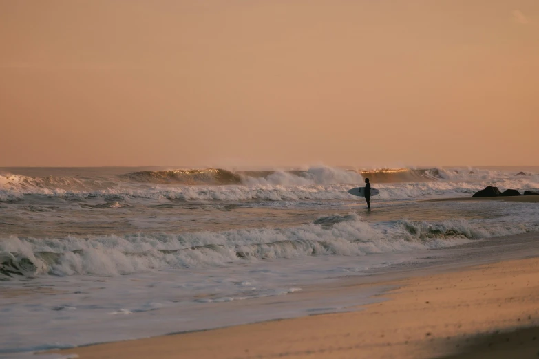 a person in the ocean with a surfboard