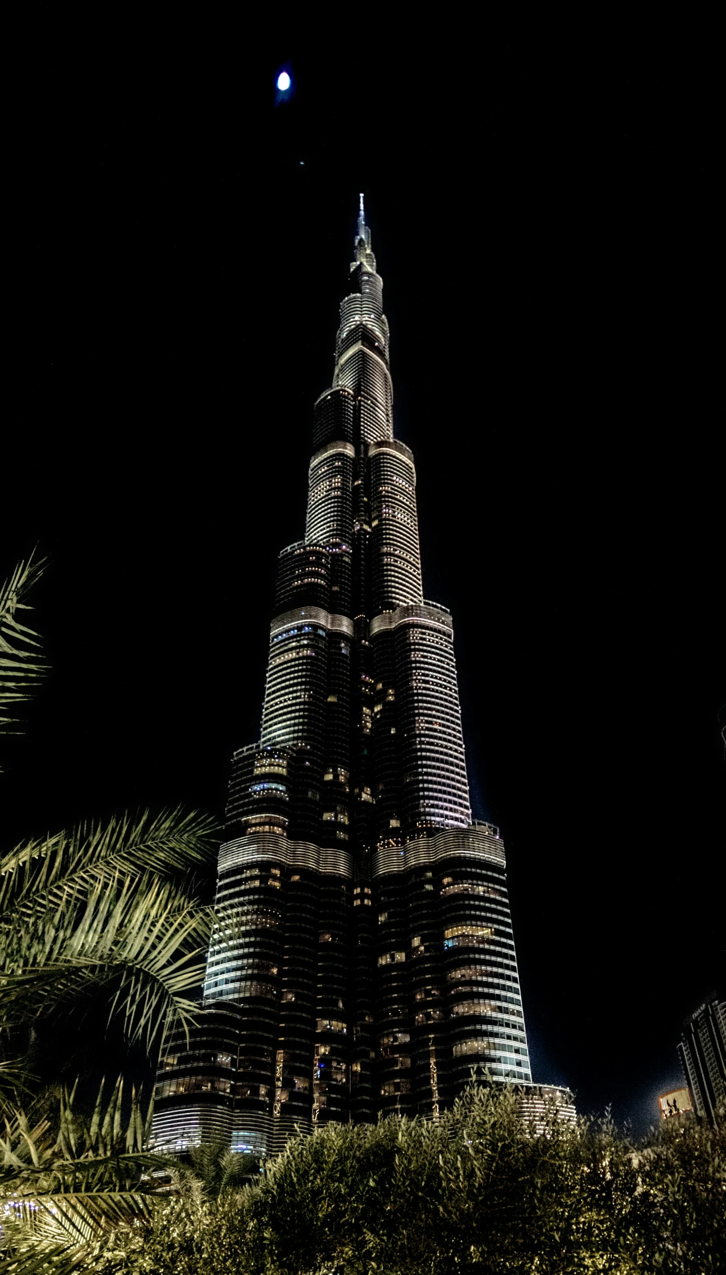 the view from the ground shows the city's skyscrs lit up