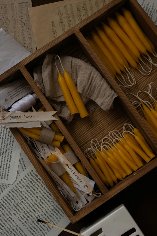 wooden boxes are full of yellow candles for decorative purposes