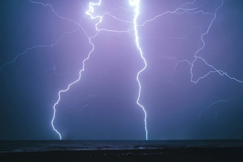 a lightning storm strikes across the sky