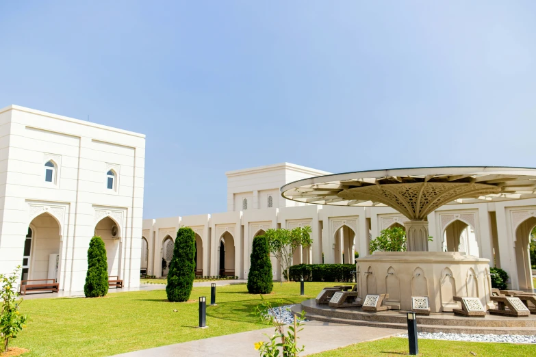 the large fountain in the center of a green yard