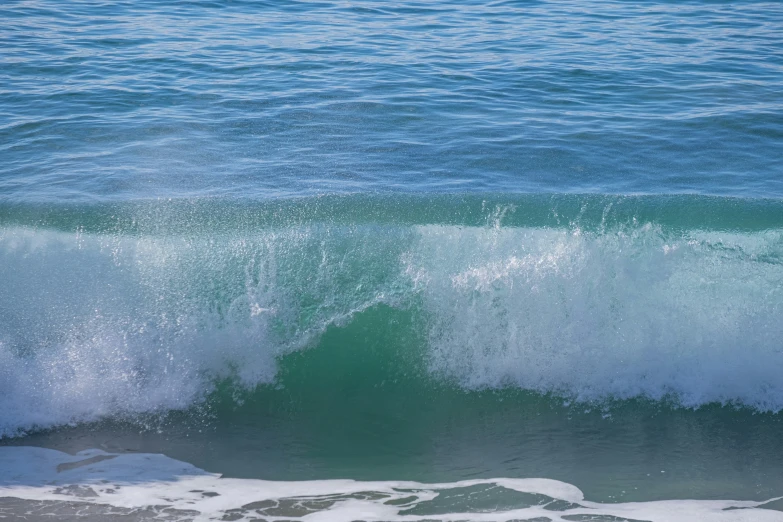 a man surfing on the ocean waves in the ocean