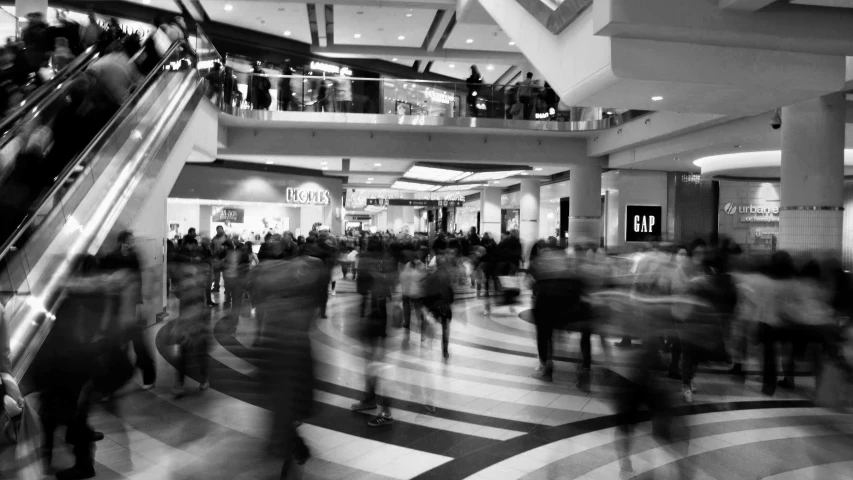 a mall with lots of people traveling and people walking around