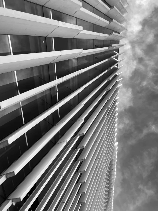 an upward view of a tall building with shutters