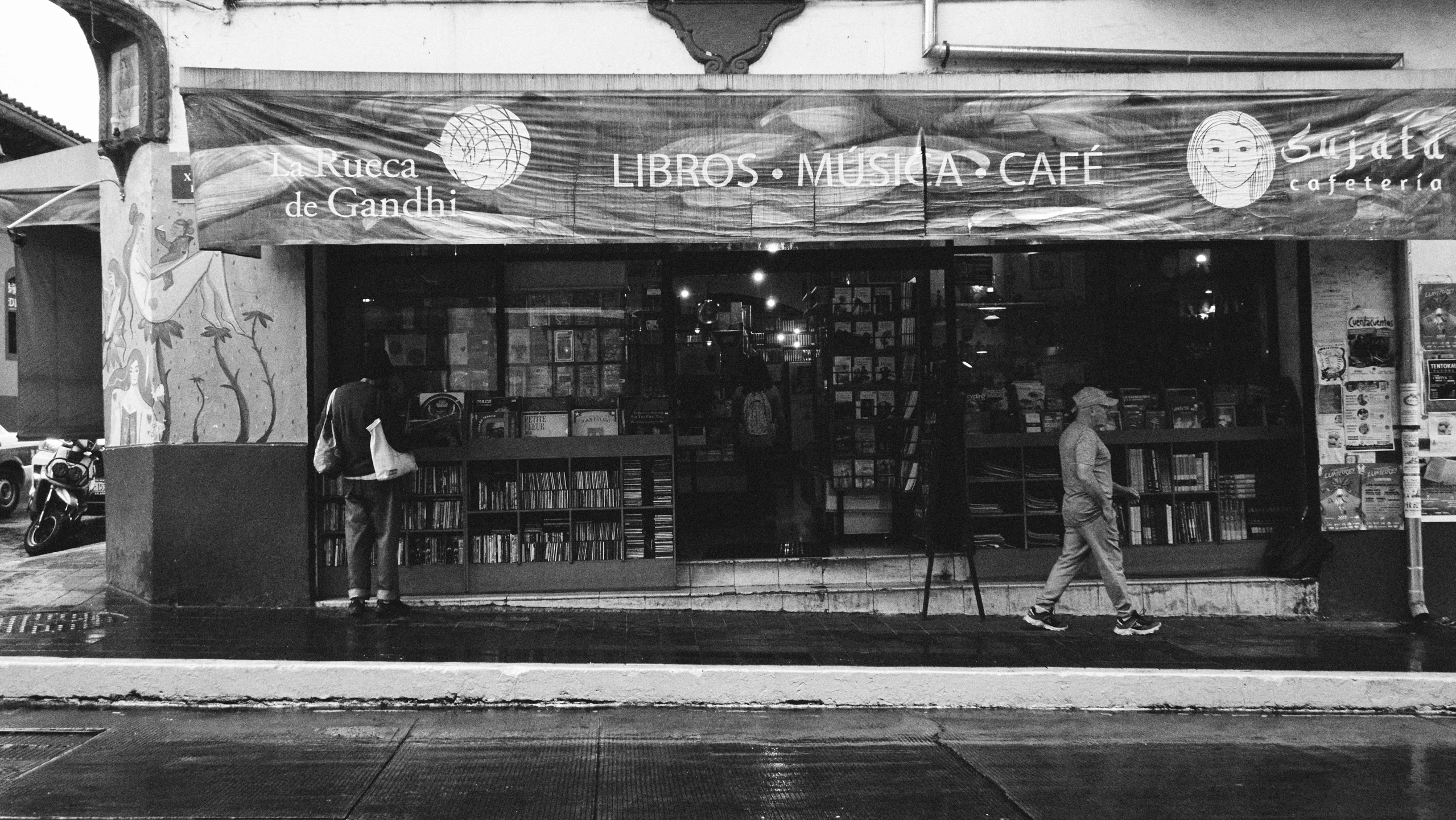 an old po of a man walking outside a bookstore