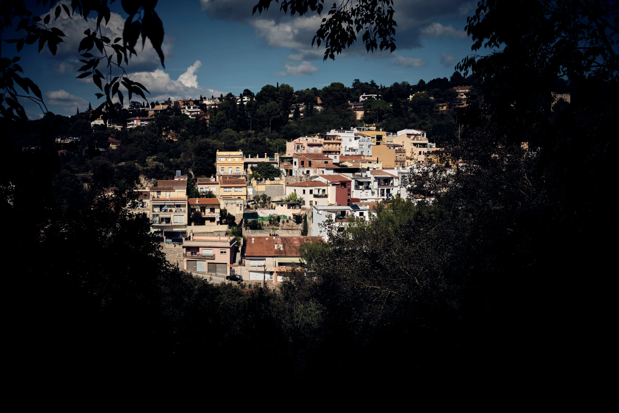 a group of buildings with trees at the bottom