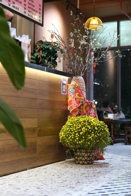 a basket with yellow flowers in it sitting on the ground