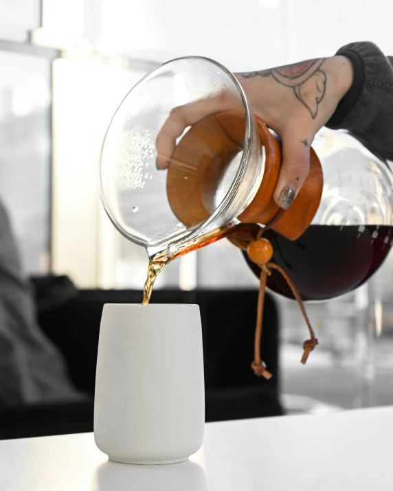 someone pours wine into a glass at a table