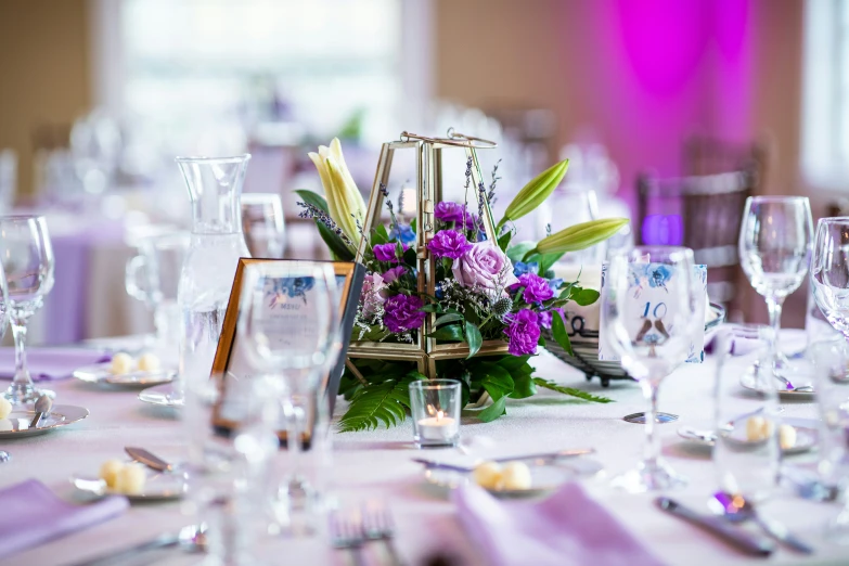 a table with plates and wine glasses is set up for a formal event