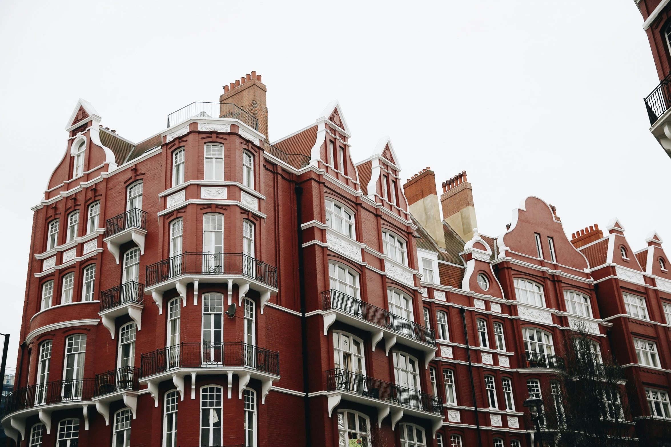 the large building has many balconies on top