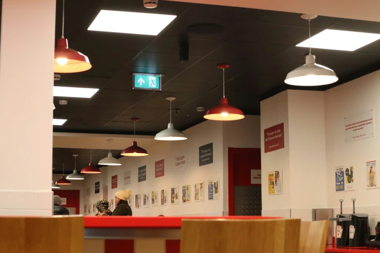 a woman is standing behind a red counter