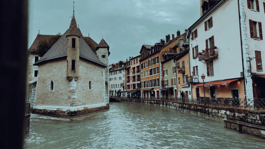 the narrow canal in the old city has several tall buildings on it