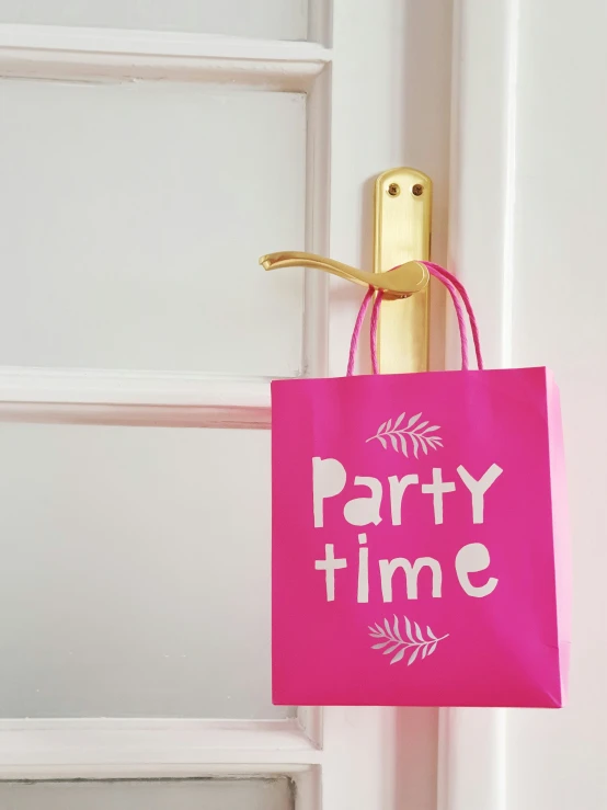 party time shopping bag hanging from a door handle