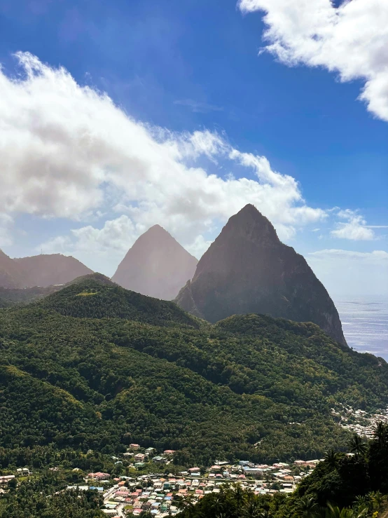 the mountain range of st lucia is pictured against a blue sky