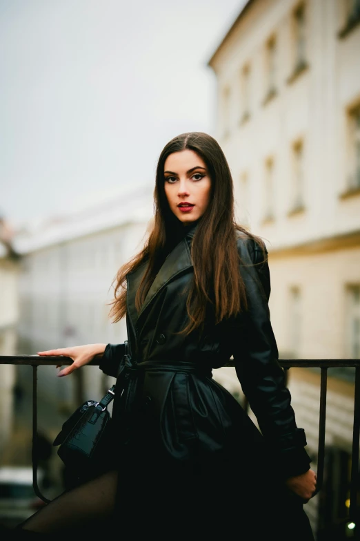 a woman leaning on a rail in the city