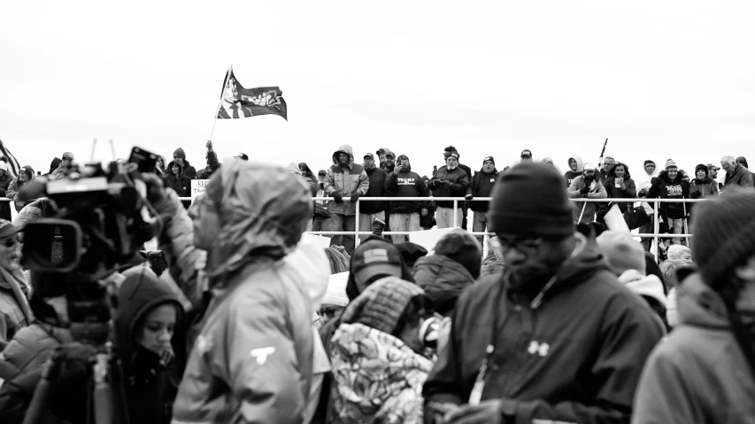 a crowd watching people standing around watching soing in the air