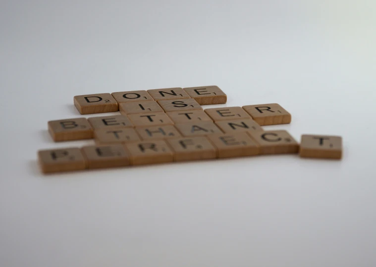 a pair of wooden scrabbles with words written on them