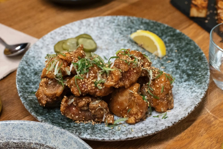 a plate full of fried vegetables on a wooden table