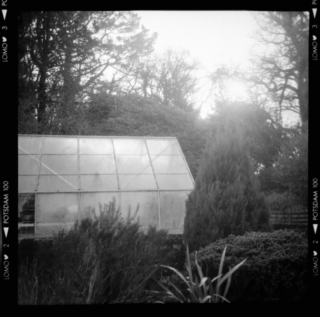 a black and white po of an old glass house