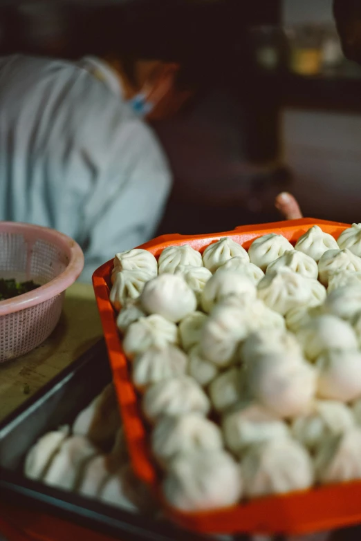 a pan filled with dumplings sitting on top of a tray