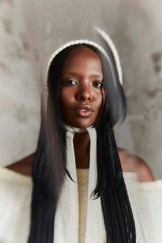 a woman with long, straight hair and a big scarf around her neck