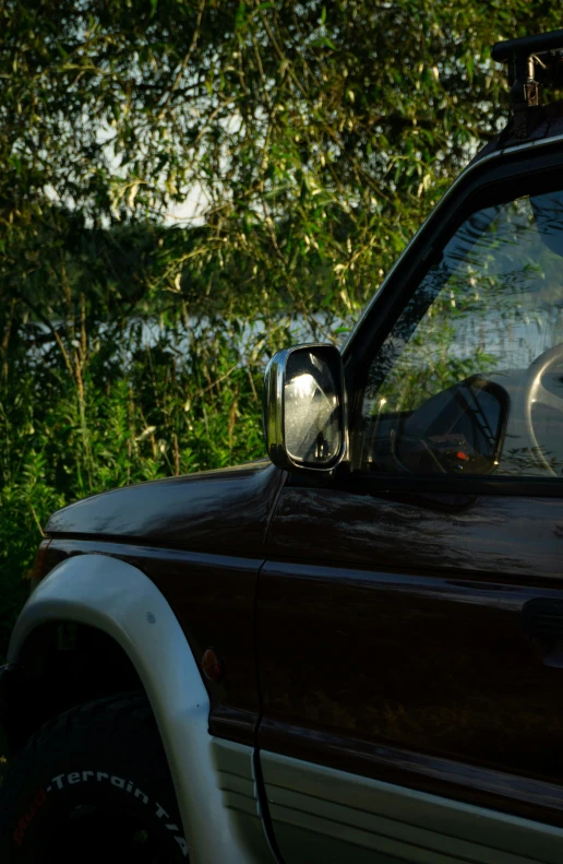 side mirror of a car with a boat in the back