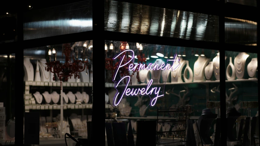 the neon lights are behind the display of jewelry
