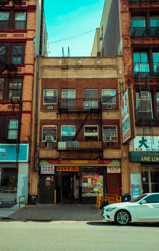 an old run down building sitting next to a car in front