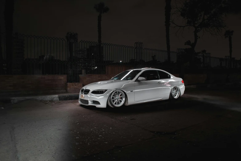 a white car parked in a driveway at night