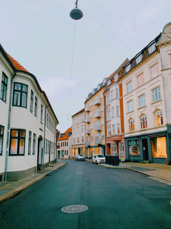 a car is parked in front of several older buildings