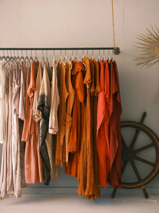 there are many coats hanging on a rack