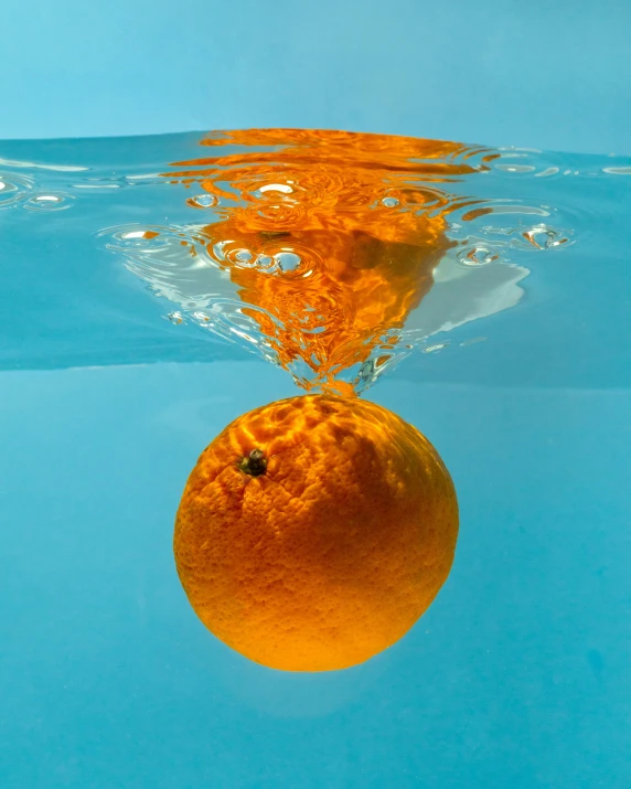 a po of an orange under water that looks like an upside down image